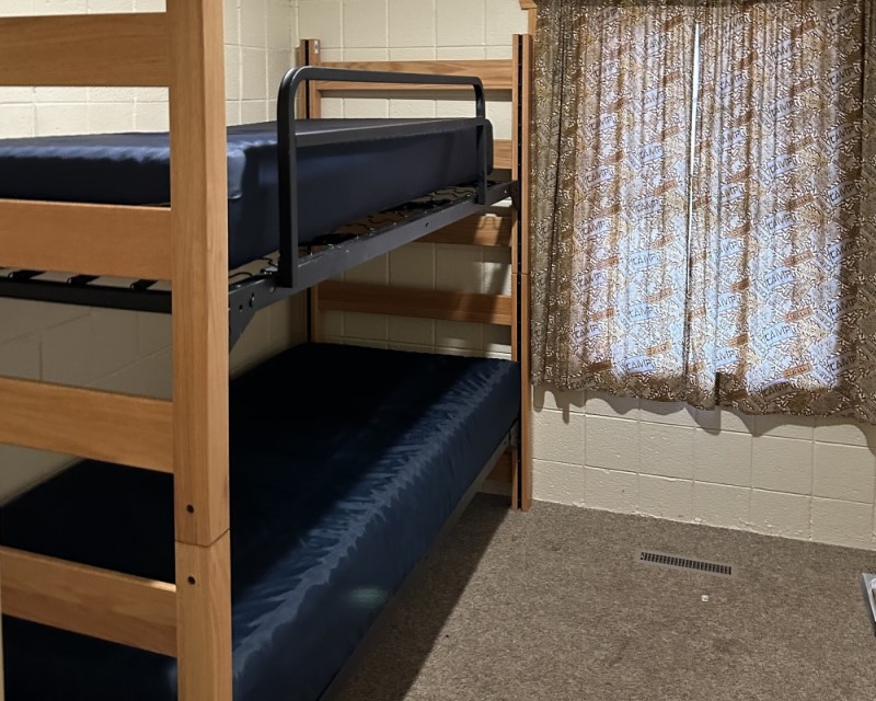 A bunk bed, with mattress pads on each bunk