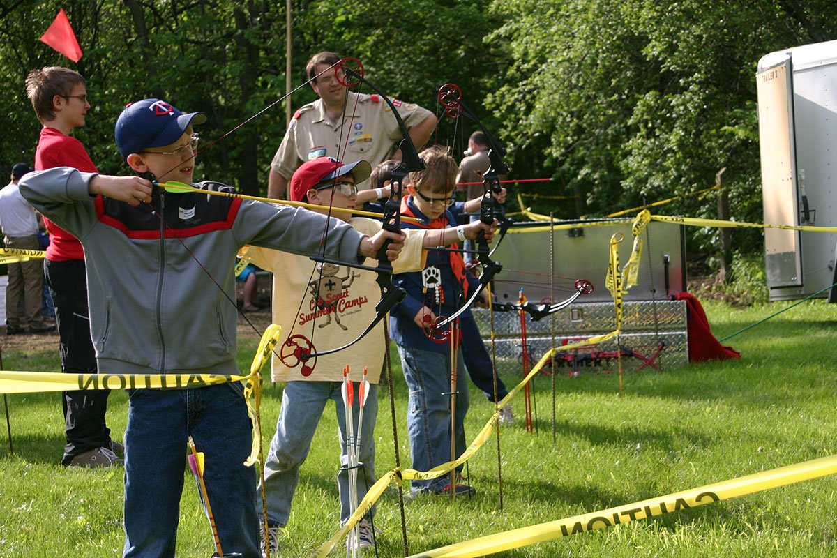 Several Scouts ina a line aiming downrange at something not visible