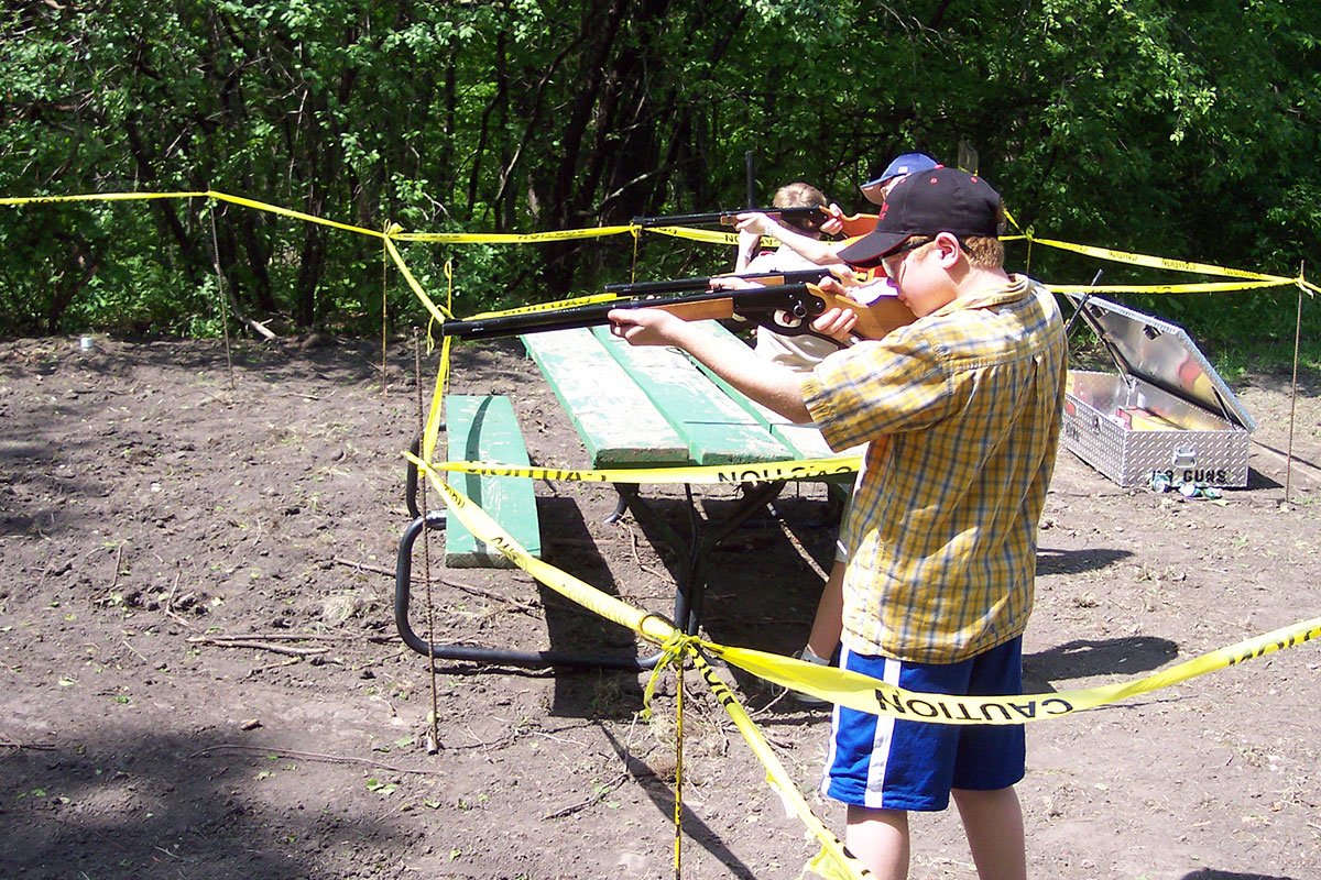 Two Scouts aiming BBs downrange at a target out of shot