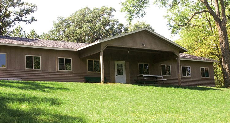 A large building set a on top of a grassy hill