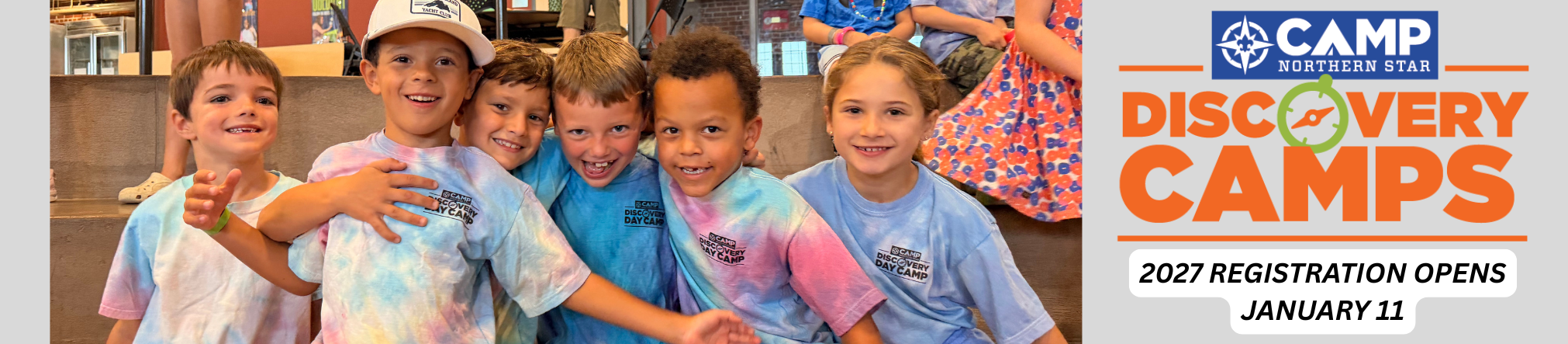 A group of kids wearing tie-dye discovery camp shirts